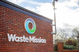 Alchemy Metals rebrands as Waste Mission 2 Waste Mission Logo on the wall, sun shining.